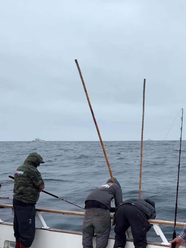 Crew setting up rods on the Polaris Supreme under overcast skies